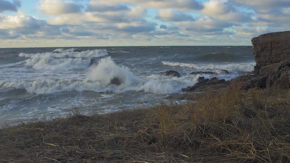 Big stormy waves breaking against abandoned seaside fortification building ruins at Karosta Northern