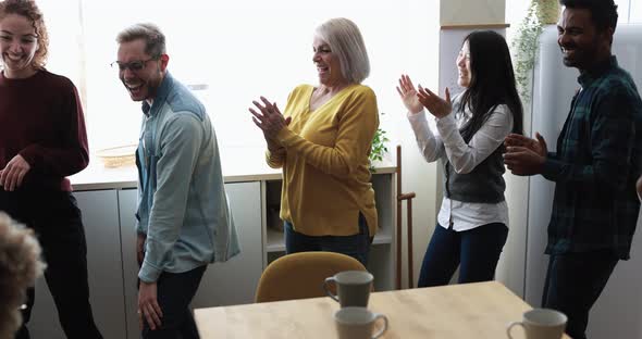 Dancing multiracial people having fun together at home kitchen