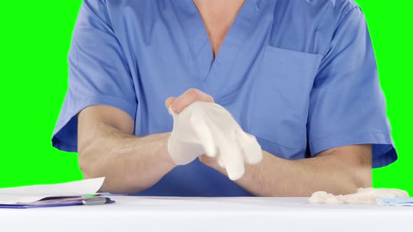 Medical Doctor Putting on Gloves. Green Screen