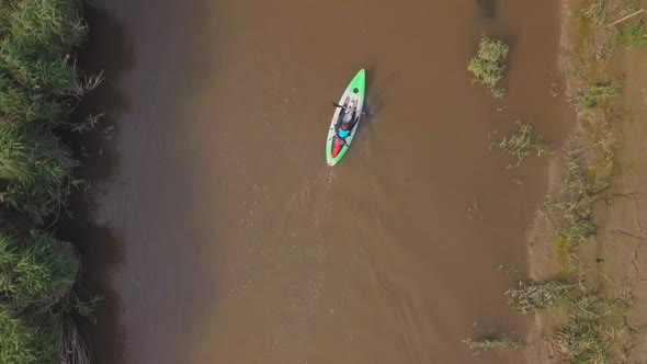 Birds-eye view of a man kayaking down a river.