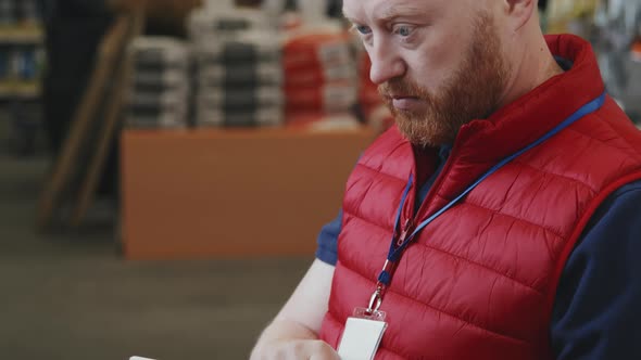 Hardware Store Male Supervisor Checking Supplies