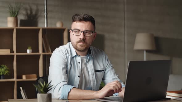 Adult Young Male Manager Entrepreneur in Glasses Working on Computer Looking in Distance Thinking of