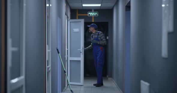 Janitor Checking Rooms in Building