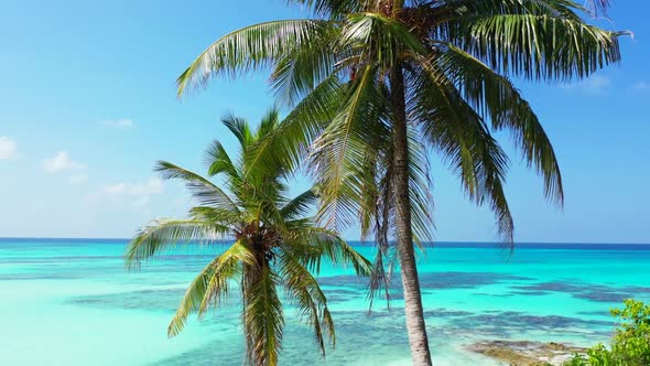 Aerial flying over sky of tropical resort beach voyage by blue lagoon with white sand background of 