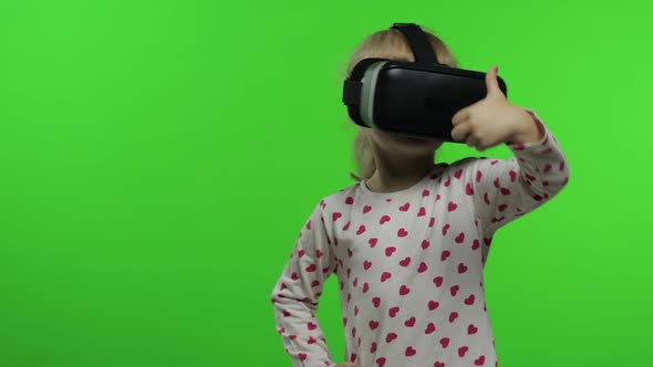 Child Girl Using VR Helmet To Play Simulation Game App. Watch Virtual Reality 3d Video. Chroma Key