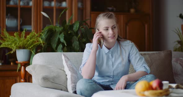 Woman Talking on Mobile at Home.