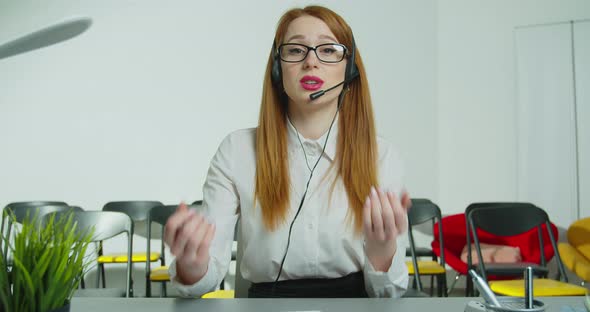 Business Woman Trainer Teacher Tutor in in Headset with Microphone Looks Camera Records Online