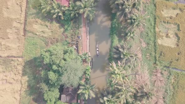 Boat trip in Kerala backwaters at Alleppey, India. Top down aerial drone view