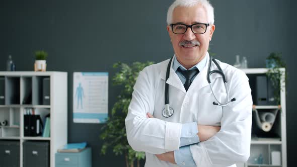 Friendly Smiling Doctor Standing Alone in Clinic Looking at Camera with Happy Face