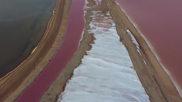 Drone shot of a salt mine in Namibia - drone is revealing pink lakes caused by salt production. Snip