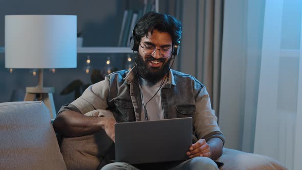 Arabian Indian Funny Happy Bearded Man Wears Wireless Headphones Having Fun Listening Music with