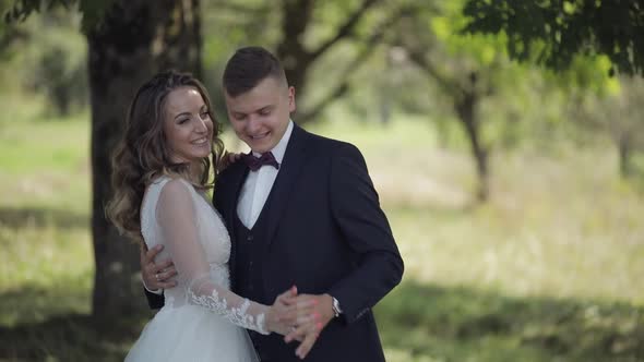 Caucasian Groom with Bride in the Park. Wedding Couple. Happy Family. Newlyweds