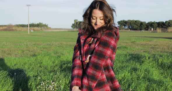 Pretty Girl with Red Dress in the Green Meadow