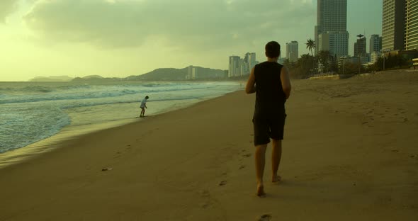 Young Caucasin Man Are Exercising with Outdoor Running with a Beautiful Sea Background