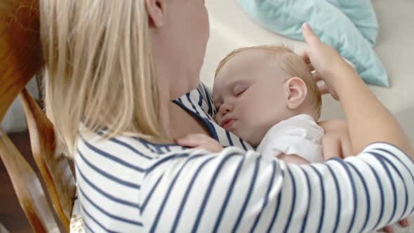 Loving Mother with Sleeping Baby Son