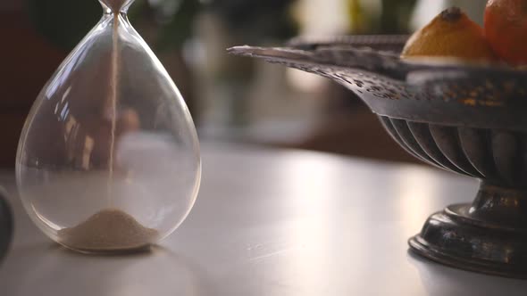 Hourglass sand falling in slow motion cinematic paning