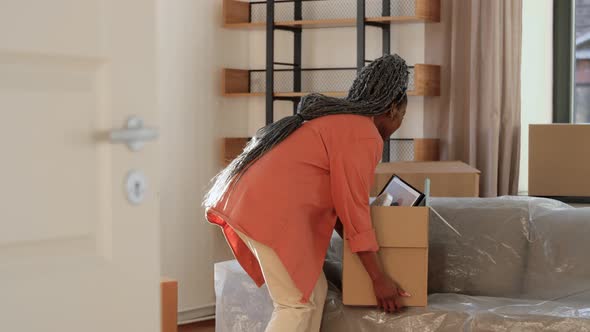 Happy Woman with Box Moving to New Home