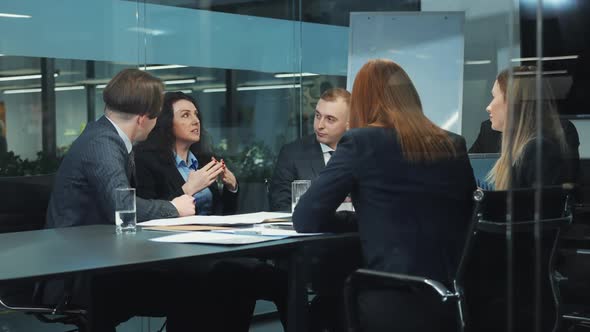 Team of Managers Doing Business Planning at Meeting in Office