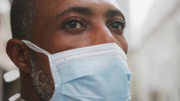 African american man on the go wearing coronavirus covid19 mask