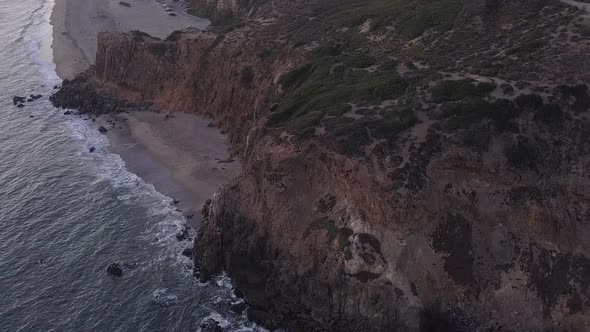 AERIAL: Flight Over Malibu, California View of Beach Shore Line Pacific Ocean at Sunset with