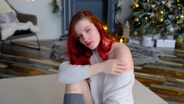 a Beautiful Redhaired Woman in Anticipation of Christmas or New Year's Eve