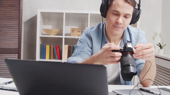 Workplace of freelance worker at home office. Young man works using computer.