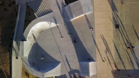 Aerial view of people skating and cycling in an urban setting.