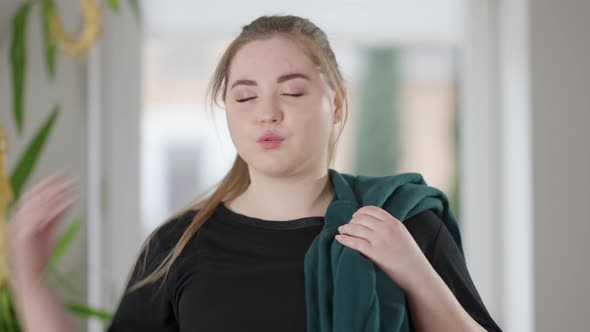 Portrait of Tired Overweight Sportswoman Wiping Forehead with Hand and Smiling Looking at Camera