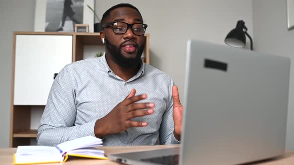 An AfricanAmerican Guy Using Laptop Video Call