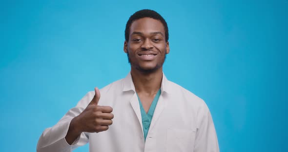 Sincere Approval Concept. Young Black Medical Doctor Gesturing Thumb Up and Smiling To Camera