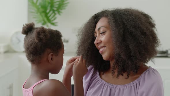 Closeup Portrait of a Happy Family of Two Adorable Preschool Girl Stroking Her Mom's Hair Hugging