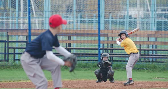 Baseball Tournament at School, Boys Play Baseball, the Pitcher Throws the Ball Toward a Batter