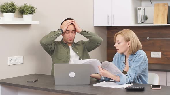 Puzzled Thoughtful Family Sitting at Home Studying Documents of Family Business and Working with