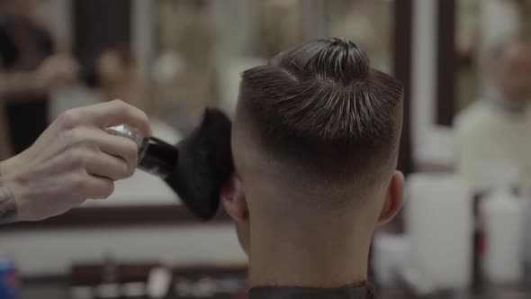 The Client Receives a Haircut in a Barbershop.