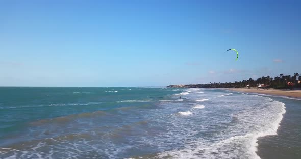 Aerial drone view of a man kiteboarding on a kite board