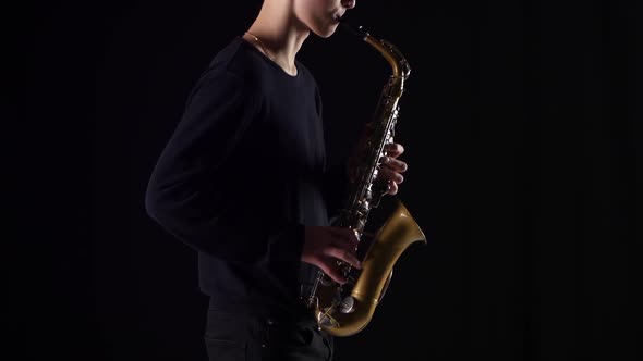 Silhouette of a Sax Player. Man Playing a Musical Instrument