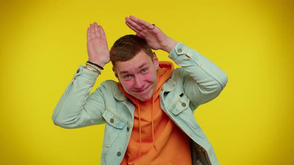 Lovely Funny Man Smiling Friendly Doing Bunny Ears Gesture on Head Having Fun Fooling Comical Mood