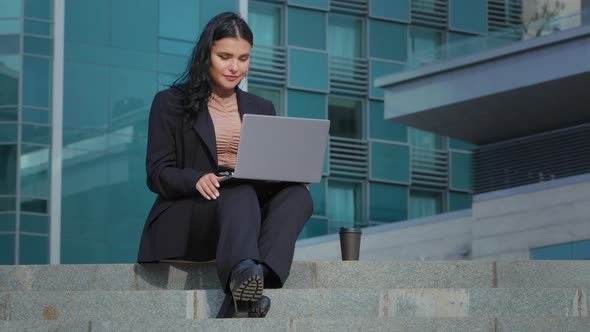 Young Businesswoman Talking Using Webcam on Laptop Outdoors Speaking Into Camera at Remote Interview