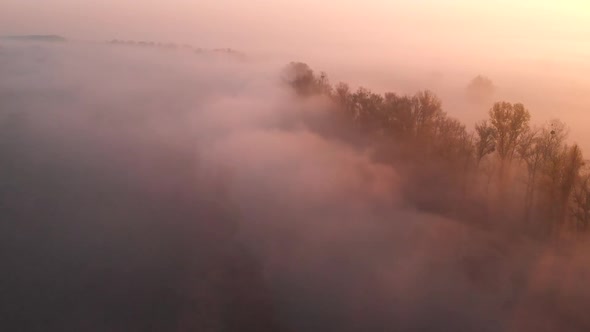 Aerial Drone View of Sunrise Over Misty River