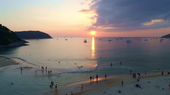 Colorful sunset above the sea surface with sail boats Aerial view drone fly over Phuket sea