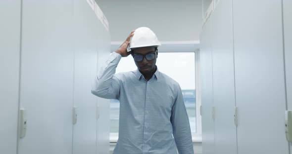 An Engineer Puts on a Helmet