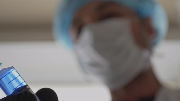 Vaccination Concept Blurred Image of a Medic with a Syringe in His Hand. A Researcher Pushes Air