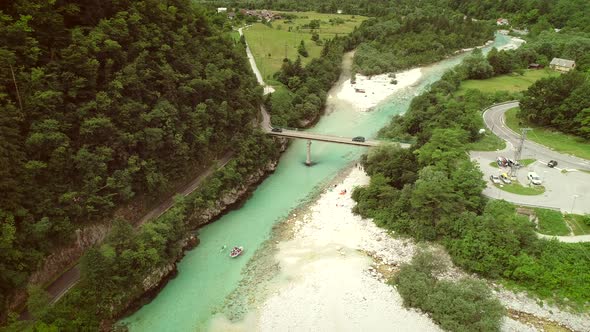 Aerial view of rafters doing rafting in turquoise water going down at Soca river