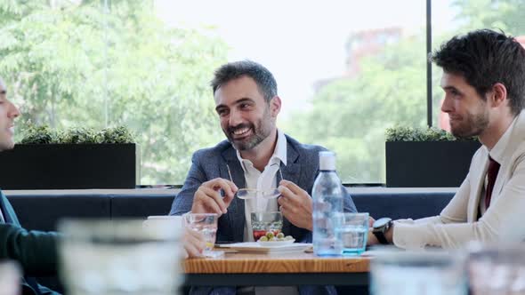 Businessmen talking during meeting in cafe