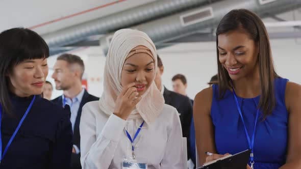 Women in the audience at a business seminar talking