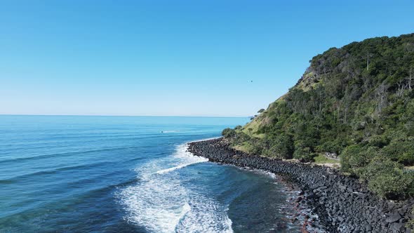 Care flight helicopter flies past as waves roll in on the world famous Burleigh Heads surf break and