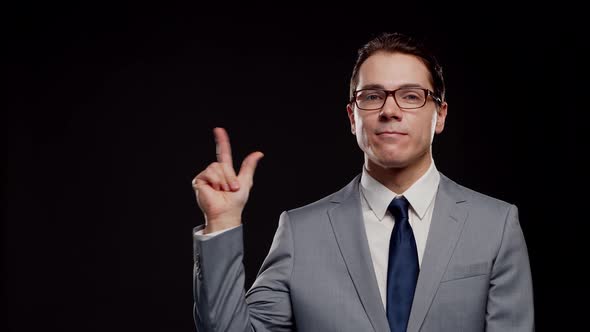 Studio portrait of successful and smart businessman in suit and tie.