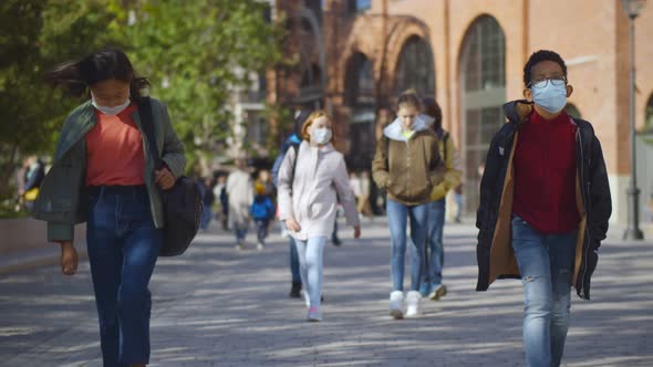 Diverse Teen School Students Wearing Face Protective Medical Mask Going Home