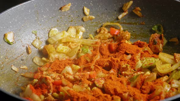 Opening Pan Lid Cover Then Add Ground Red Pepper To Chicken Breast And Vegetable, Stir. close up