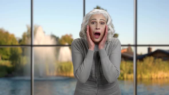 Senior Woman Making Shouting Gesture.